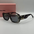 Miu Miu Rectangle Sunglasses – Transparent Grey & Dark Lenses