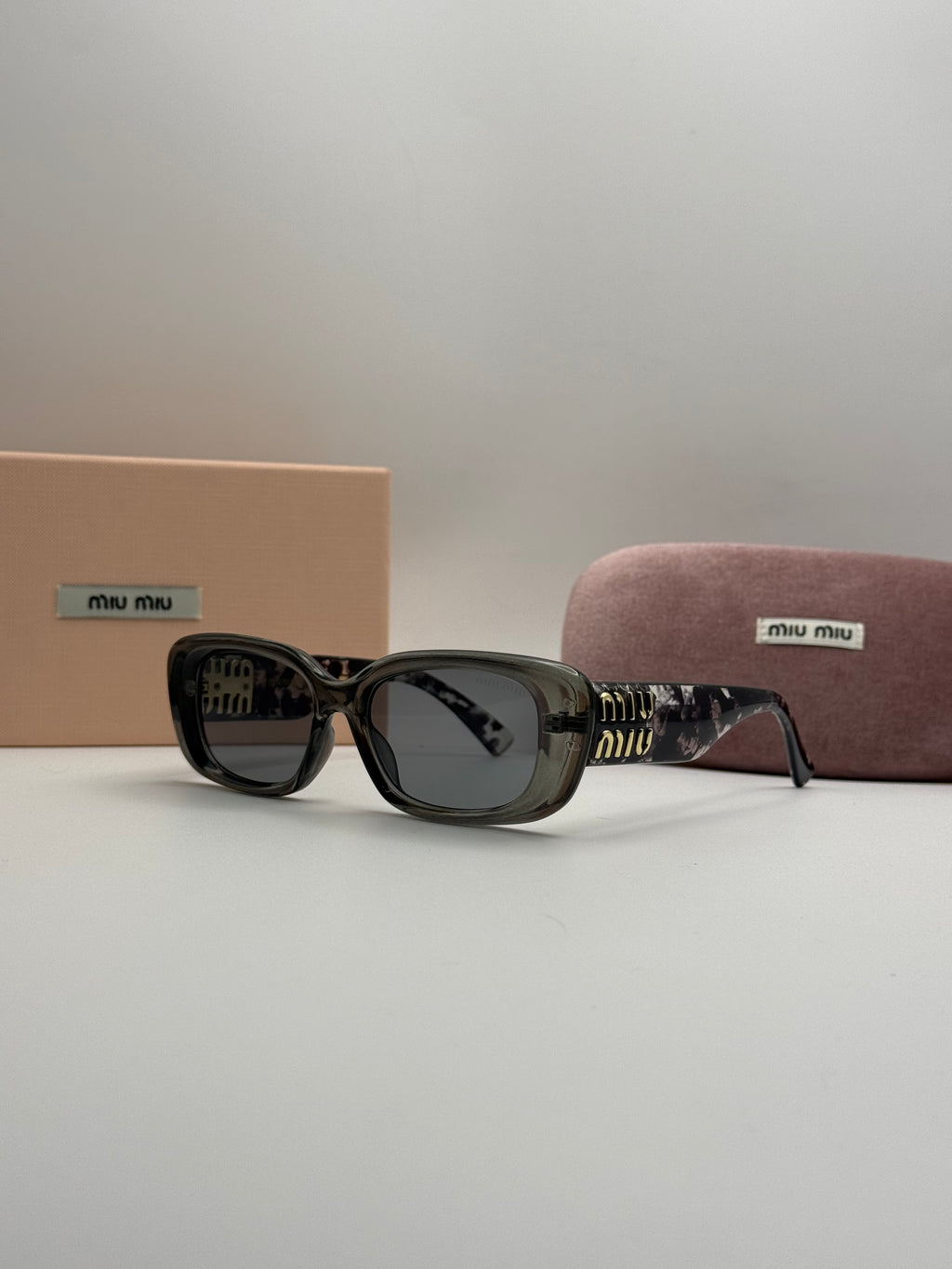 Miu Miu Rectangle Sunglasses – Transparent Grey & Dark Lenses