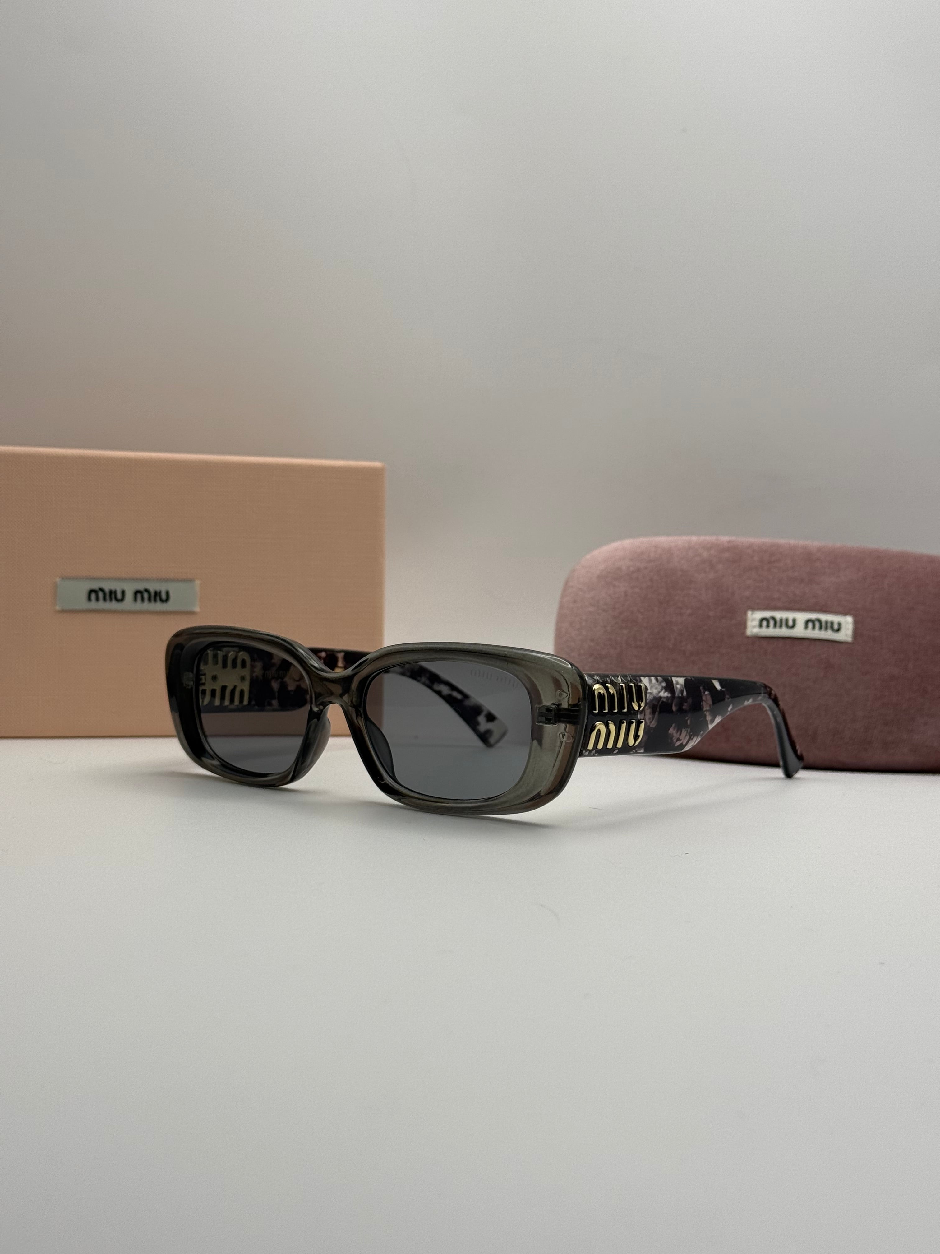 Miu Miu Rectangle Sunglasses – Transparent Grey & Dark Lenses