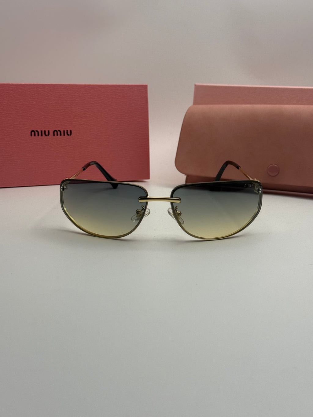 Miu Miu Rimless Sunglasses – Gold Frame / Grey-Green Gradient Lenses