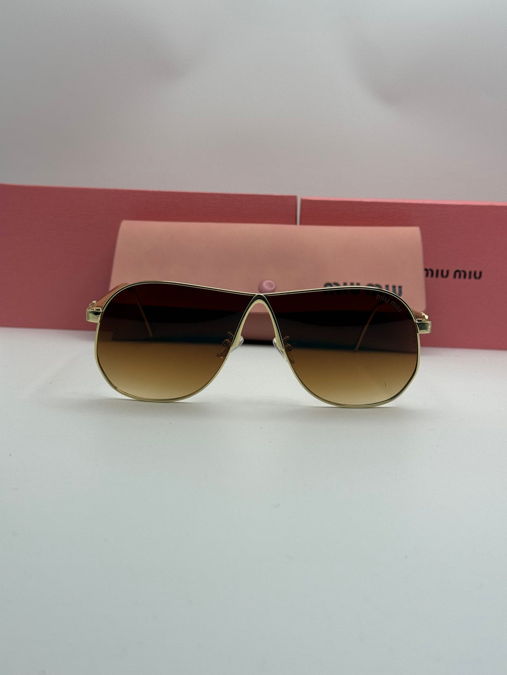 Miu Miu Aviator Sunglasses – Gold Frame / Amber Brown Gradient Lenses