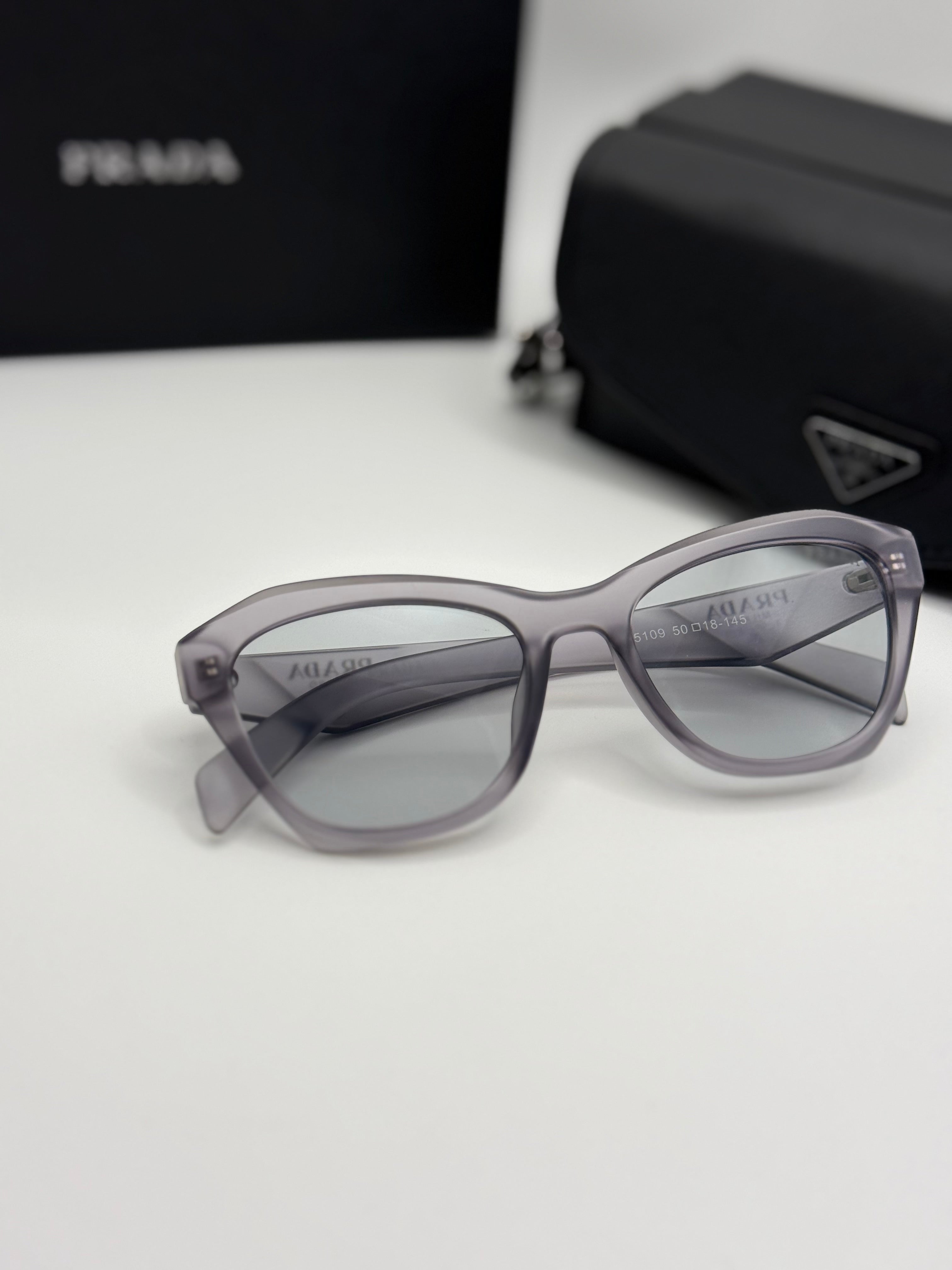 Prada Sunglasses – Grey Transparent Cat-Eye
