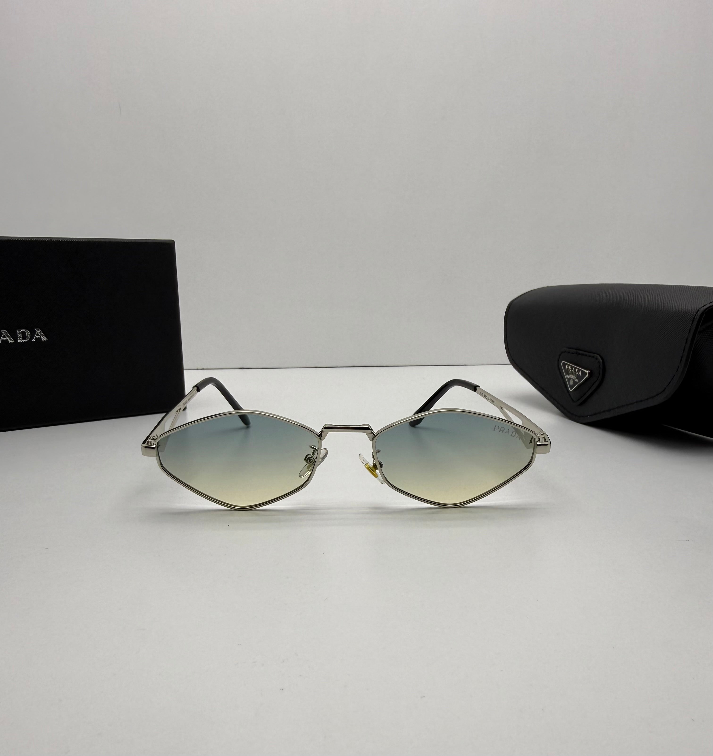 Sunglasses with Prada packaging on a light gray background